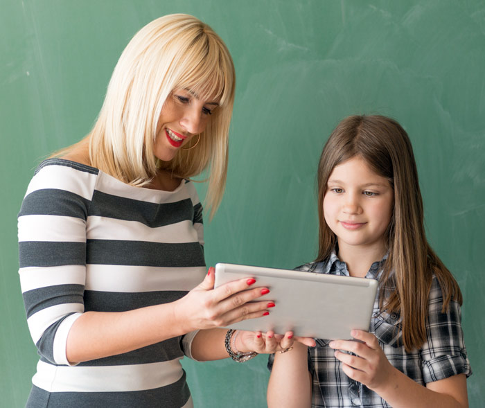 Child and teacher using an iPad